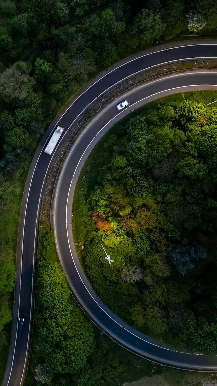aerial view of vehicles on a curved road